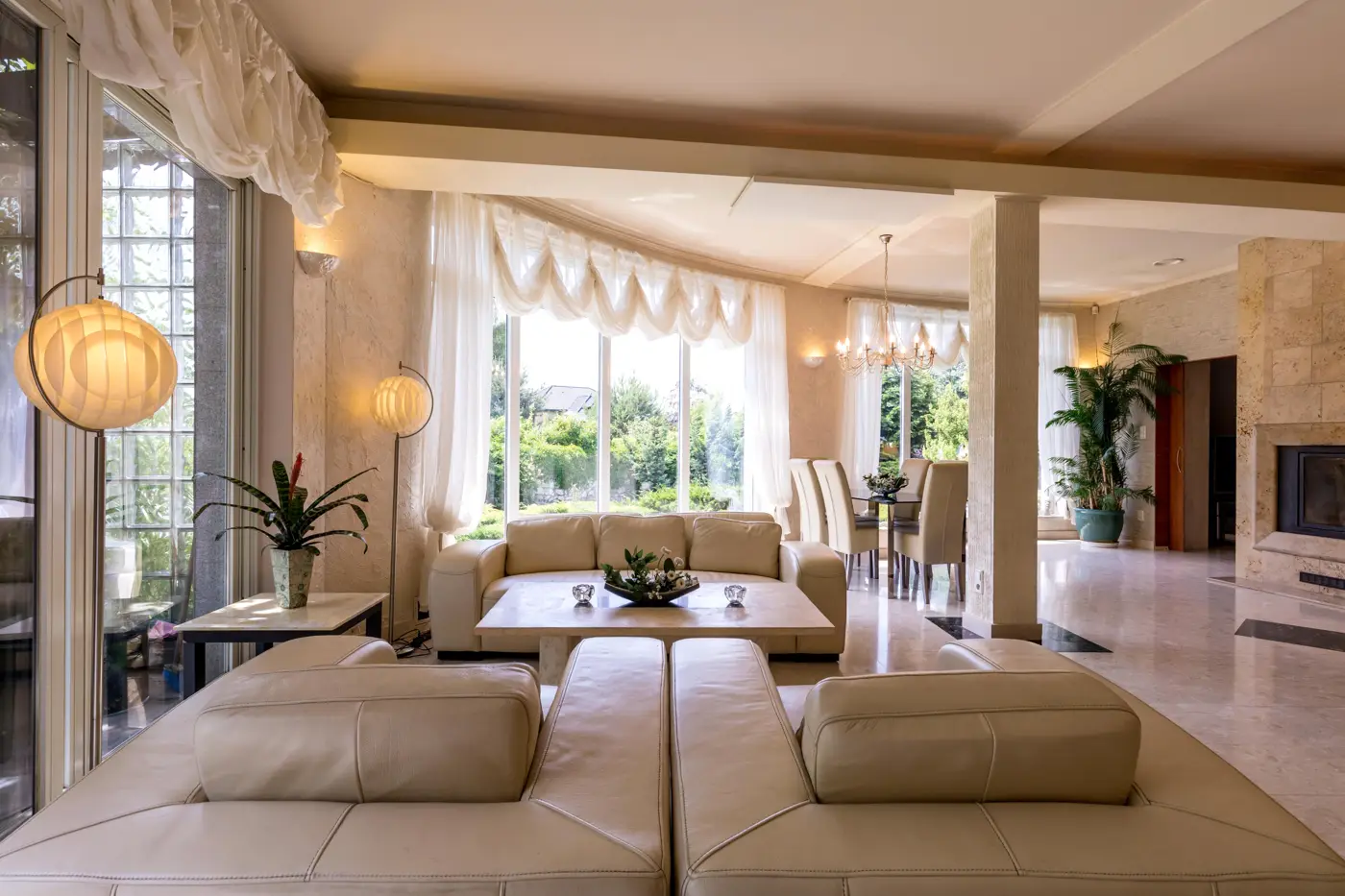 Spacious living room with beige leather sofas